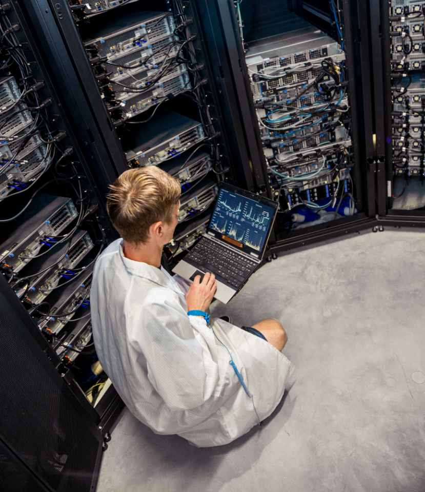 Man sat down next to data centre wiring