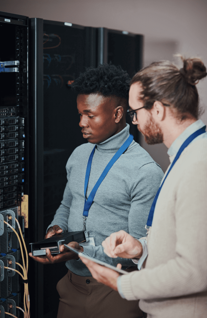 Two men looking at server cupboard