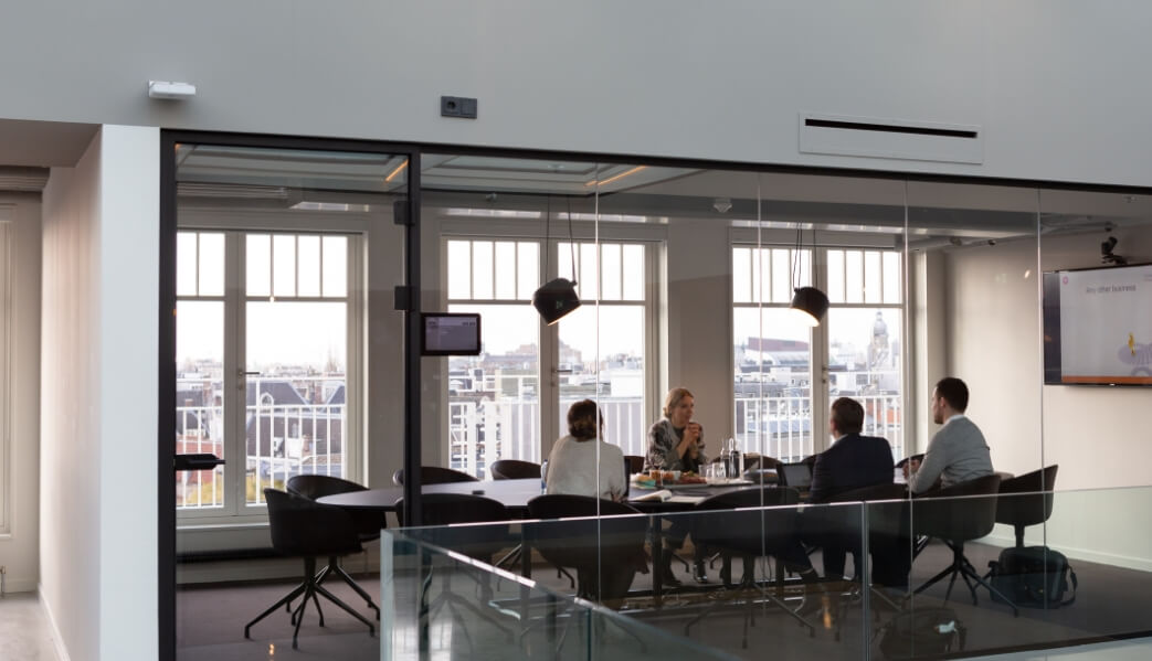 People around a desk in an office