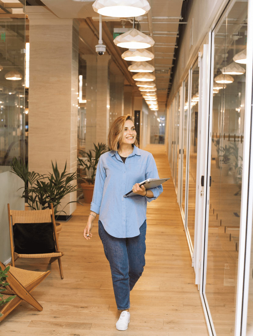 Woman walking holding laptop