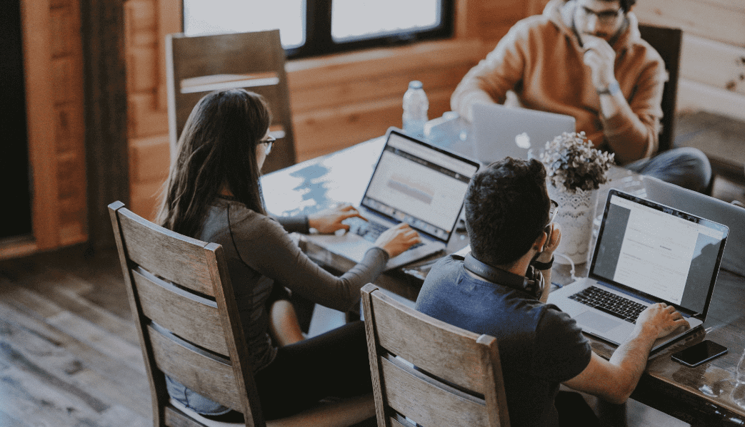 Group of people working on laptops