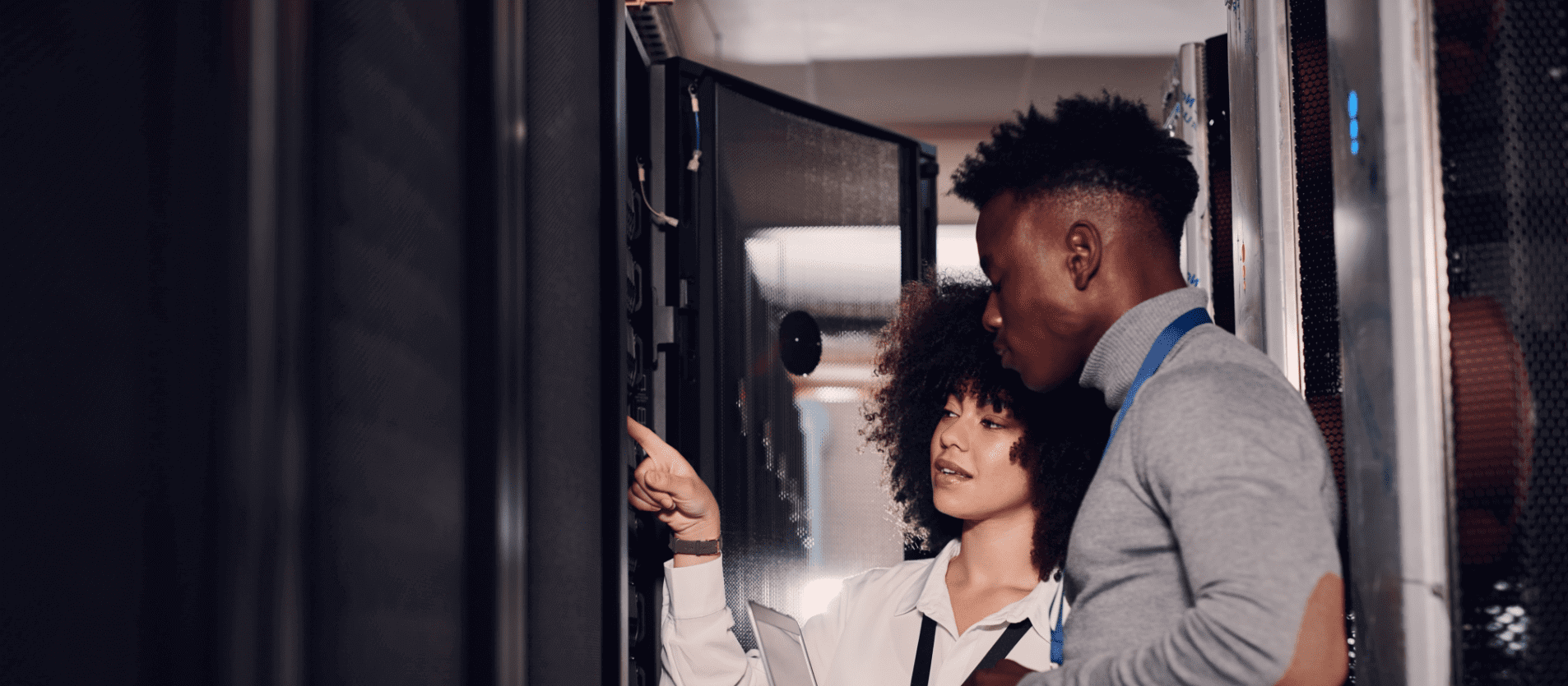 Woman pointing at server cupboard