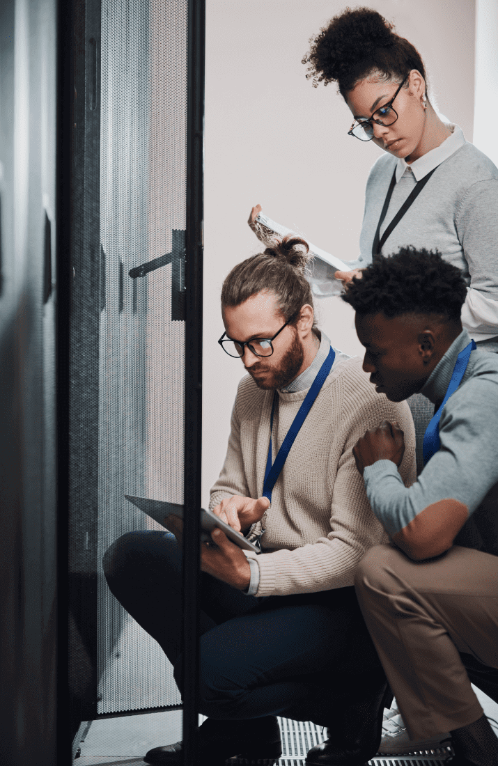 Team looking in network cupboard