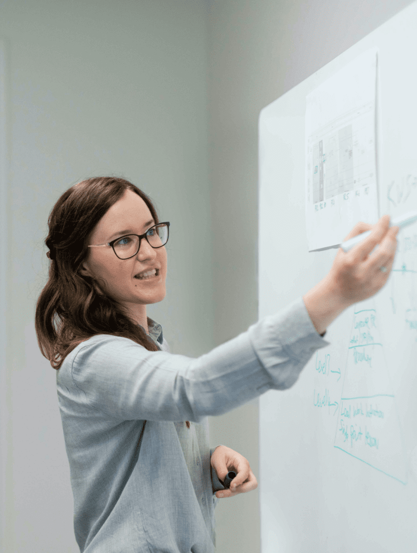 Woman writing on whiteboard