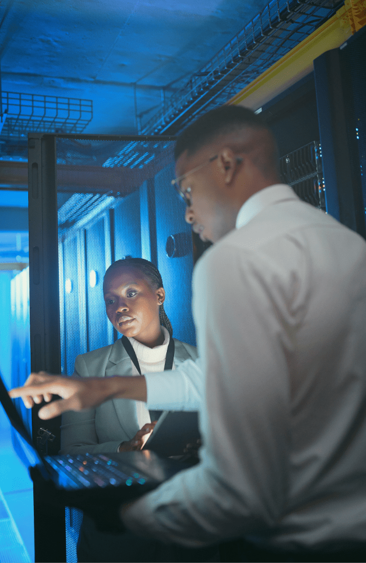 Man and woman pointing to laptop screen