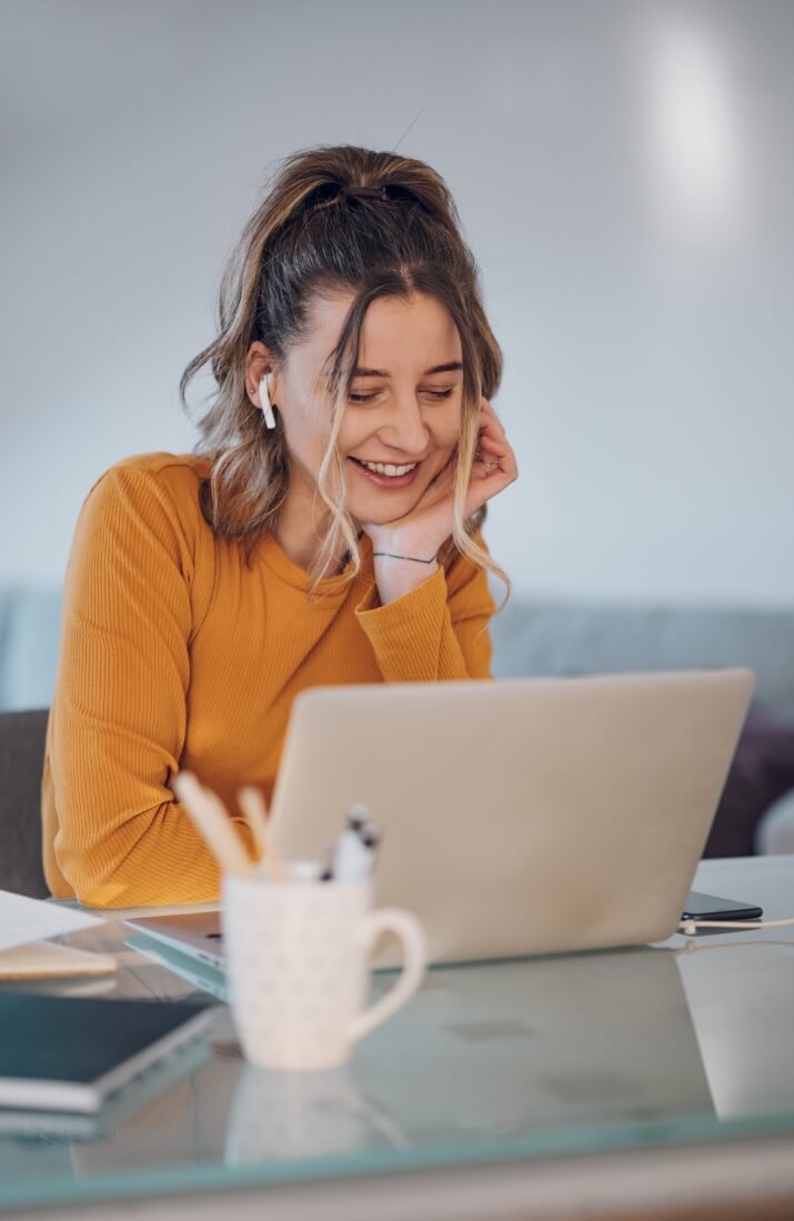 Girl smiling at laptop