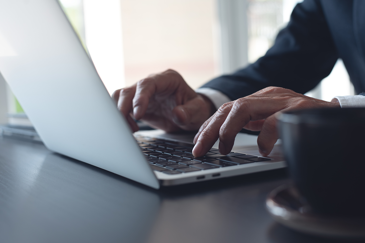 Hands typing on a keyboard, business setting