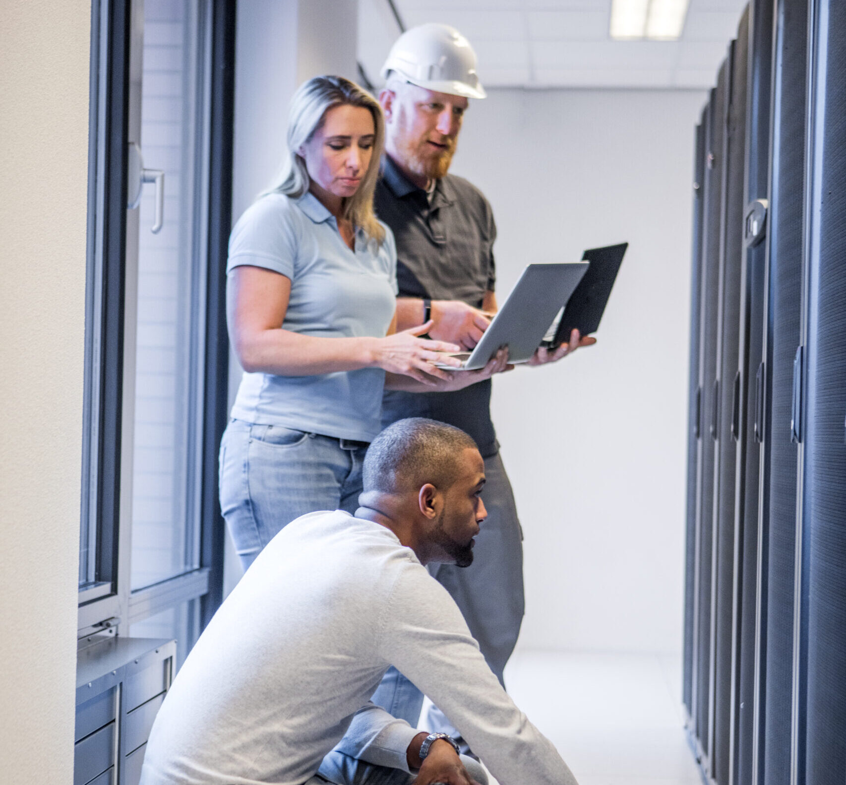 A multi ethnic team of server room technicians going back to the office and server room after lockdown