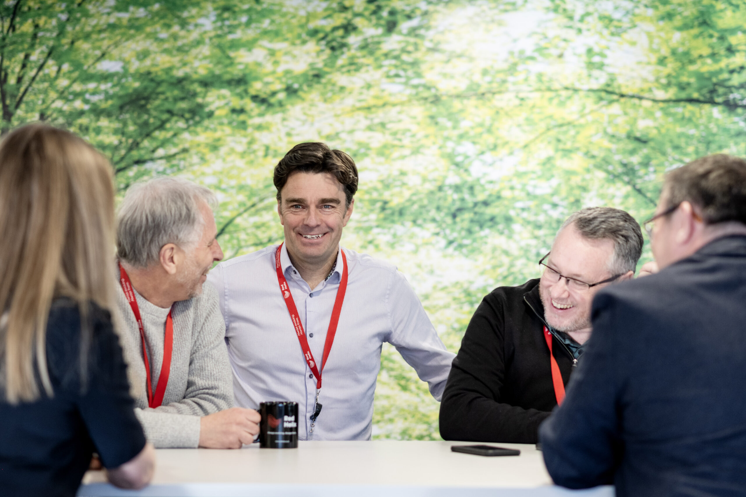Colleagues talking in an office kitchen.