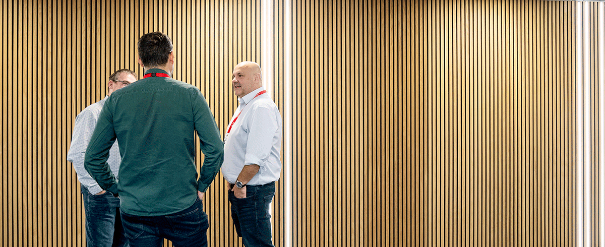 Red Helix team in front of wooden wall