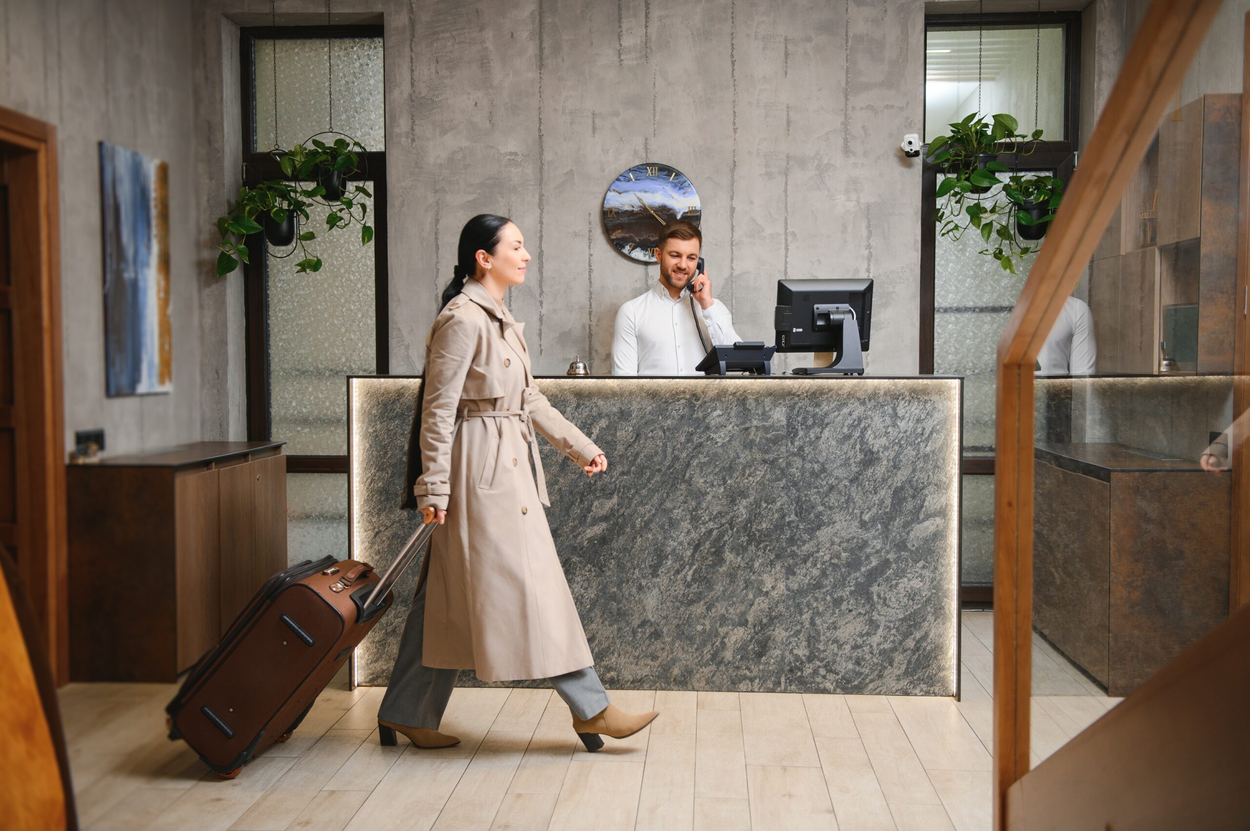 Woman walking with a suitcase in a hotel lobby